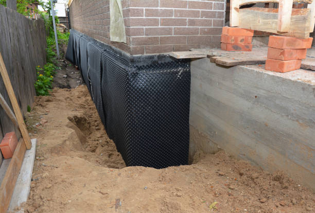 SJ Waterproofing Pros technician performing targeted Wet Basement Repair assessment in Hillsboro, KS